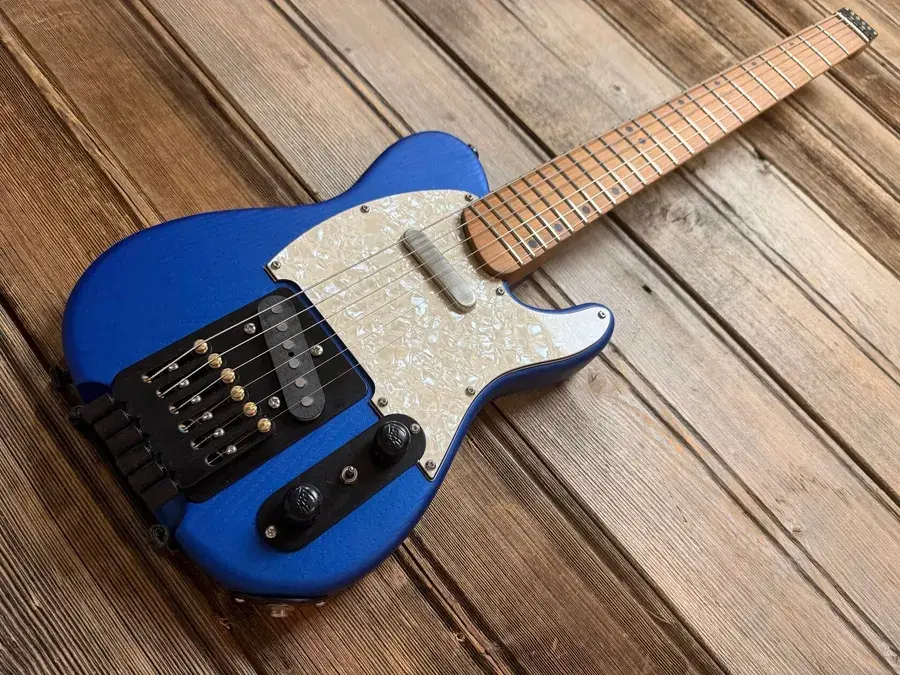 Laika Tele travel guitar in blue on the workshop deck