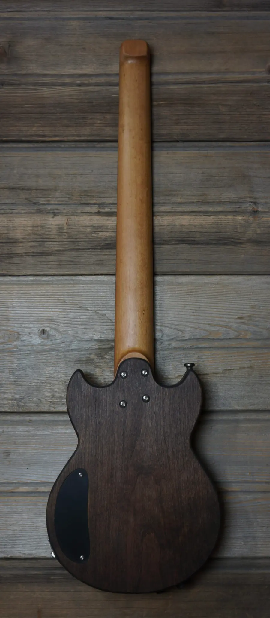 Laika Double Cut, back view: one-piece body and roasted maple neck